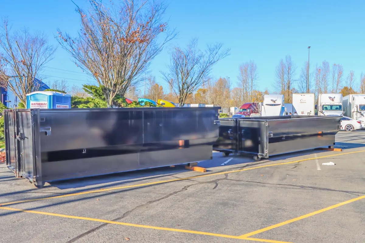 Professional dumpster rental service with roll-off container on residential driveway in Oakhurst